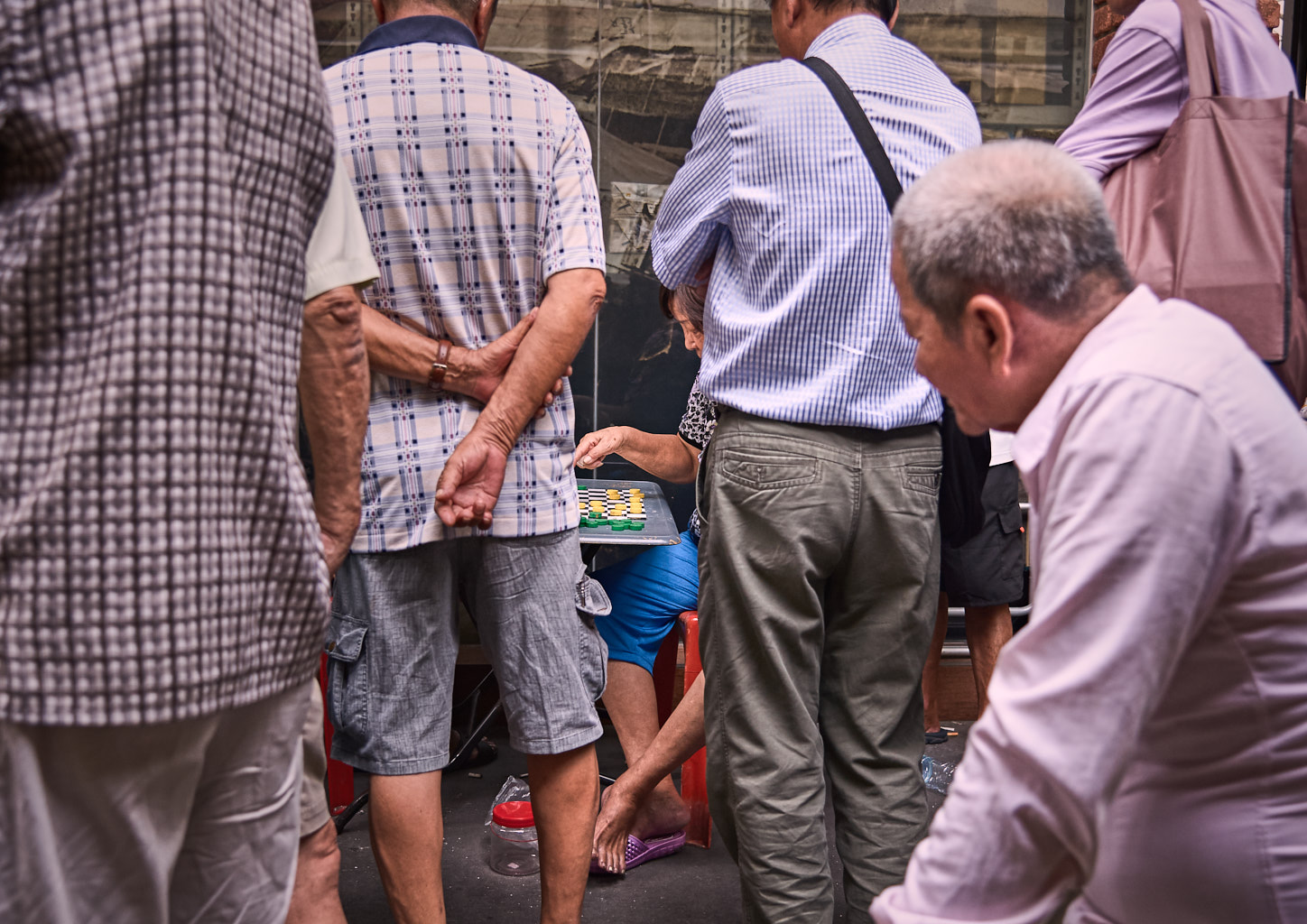 People playing board games in the streets of Singapore.