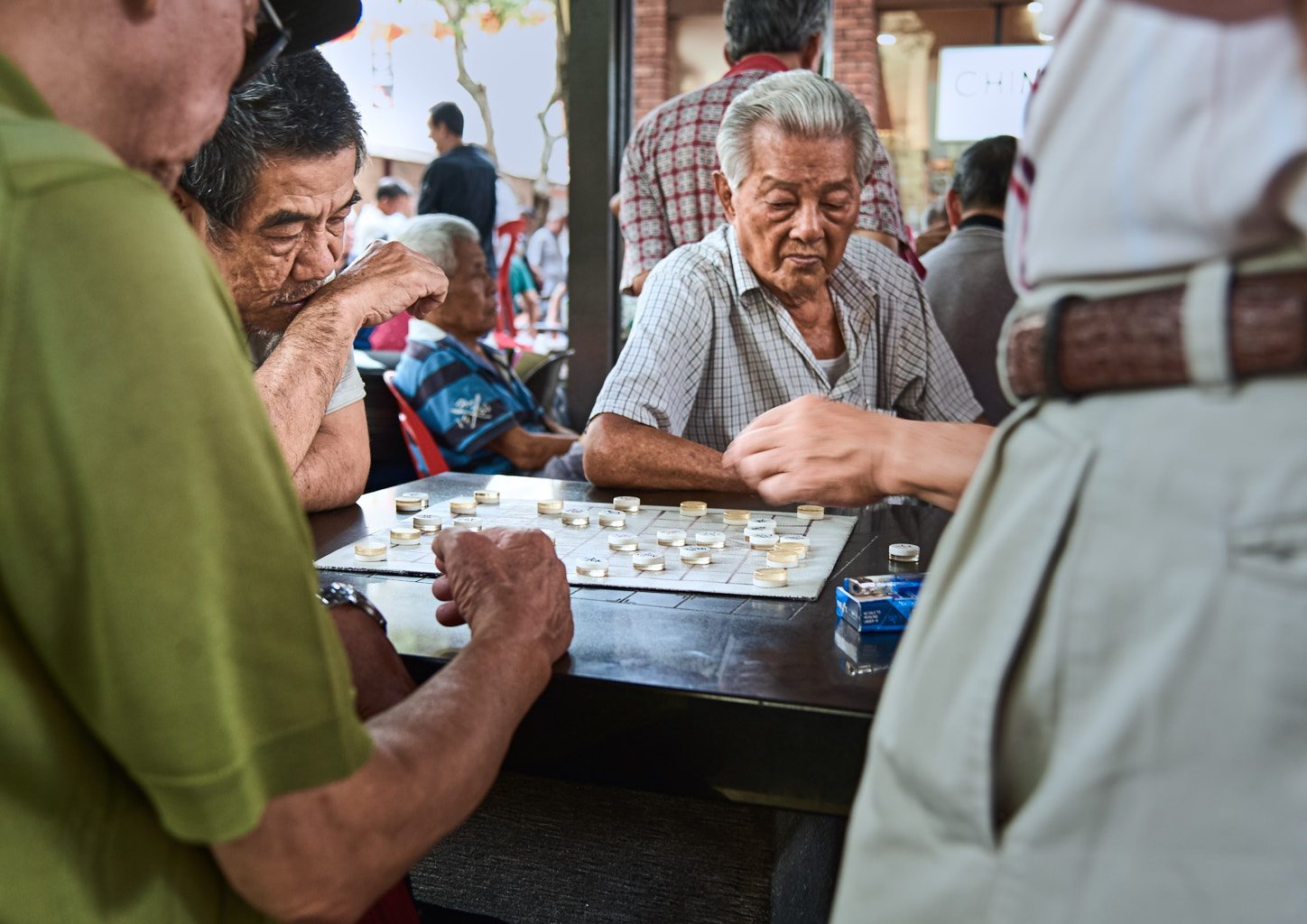 People playing board games in the streets of Singapore.