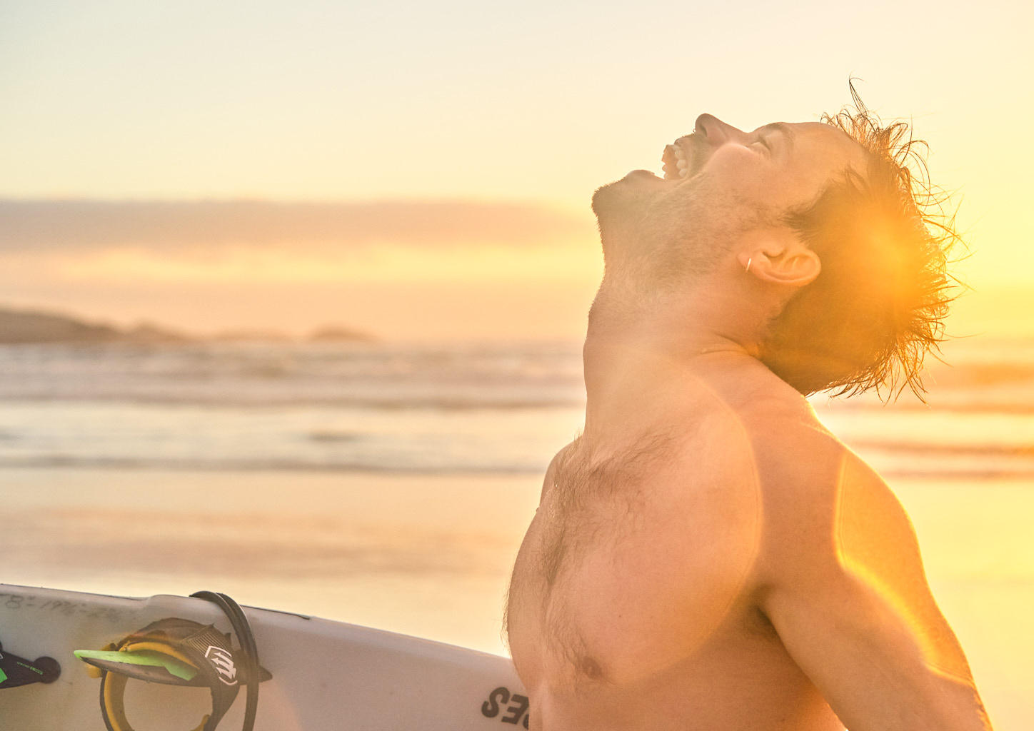 Man is happy about a epic surf session in the evening.